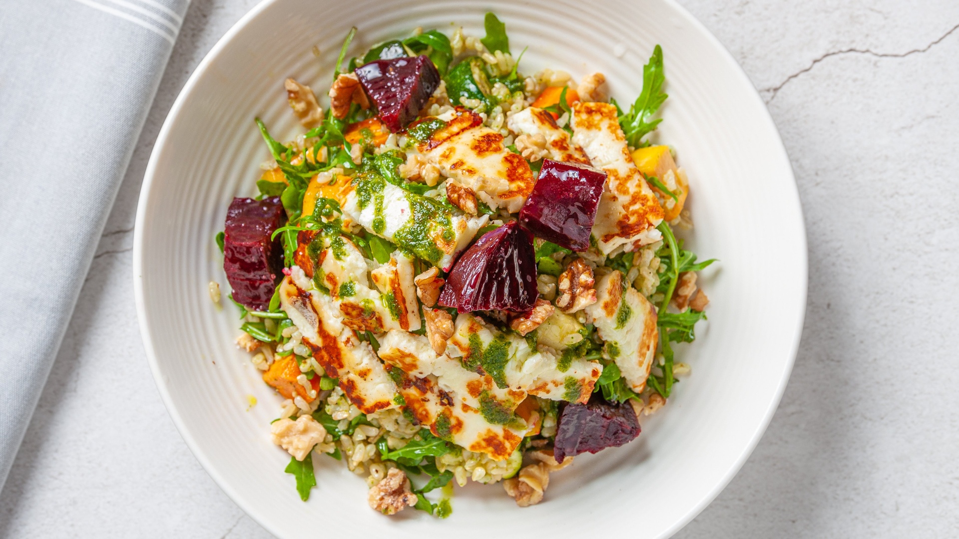 Roasted veg and brown rice with halloumi, beetroot and walnuts