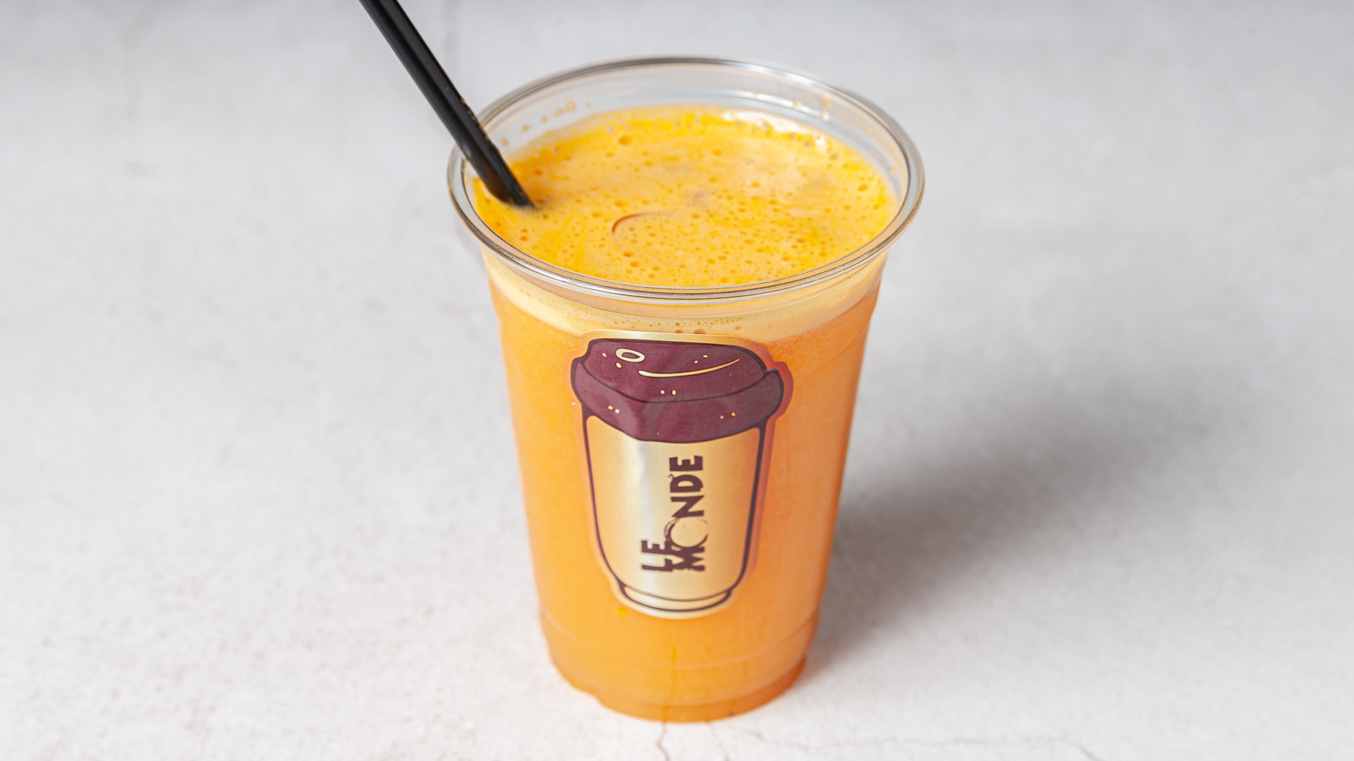 Fresh orange juice in a Le Monde cup