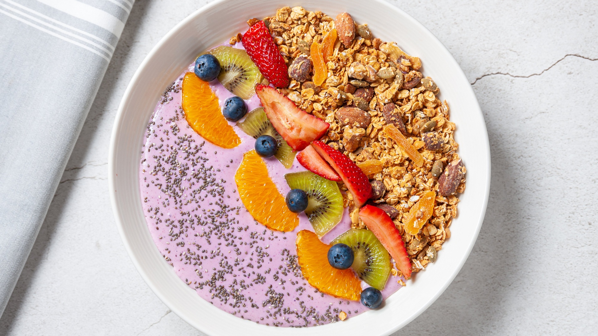 Granola bowl with berry yoghurt and fresh fruit